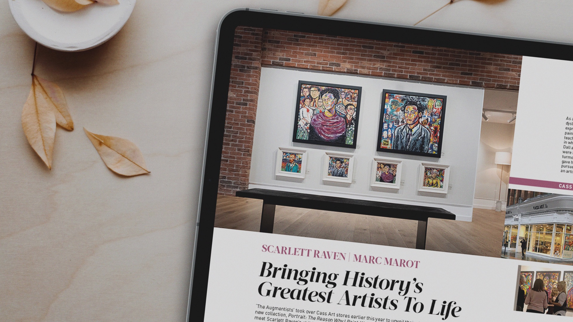 Tablet showing a Fine Art Collector article, ‘Bringing History’s Greatest Artists To Life’, beside dried leaves