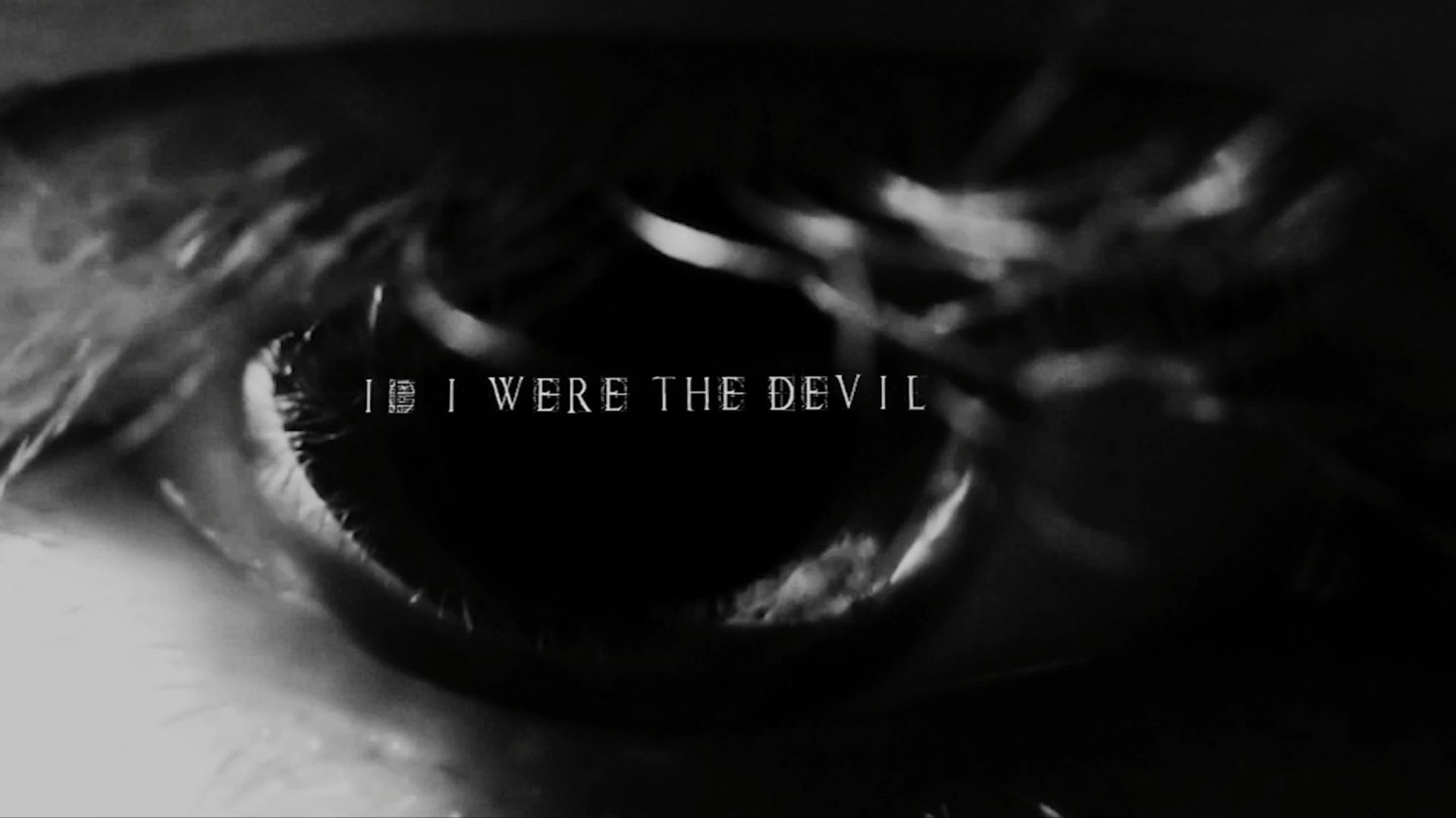 Title card for If I Were The Devil, held in close-up on an eye