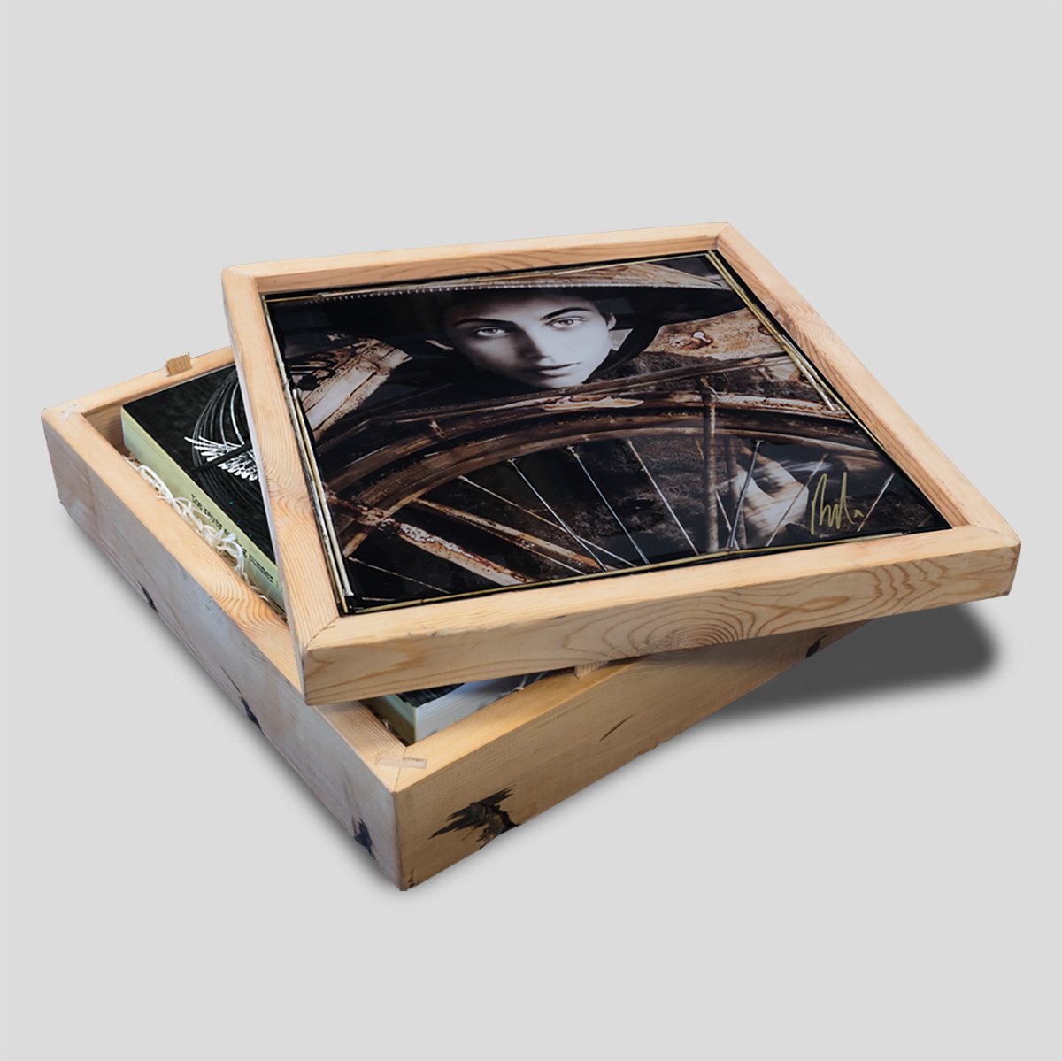 Antique pine box with its lid set askew, revealing the book inside