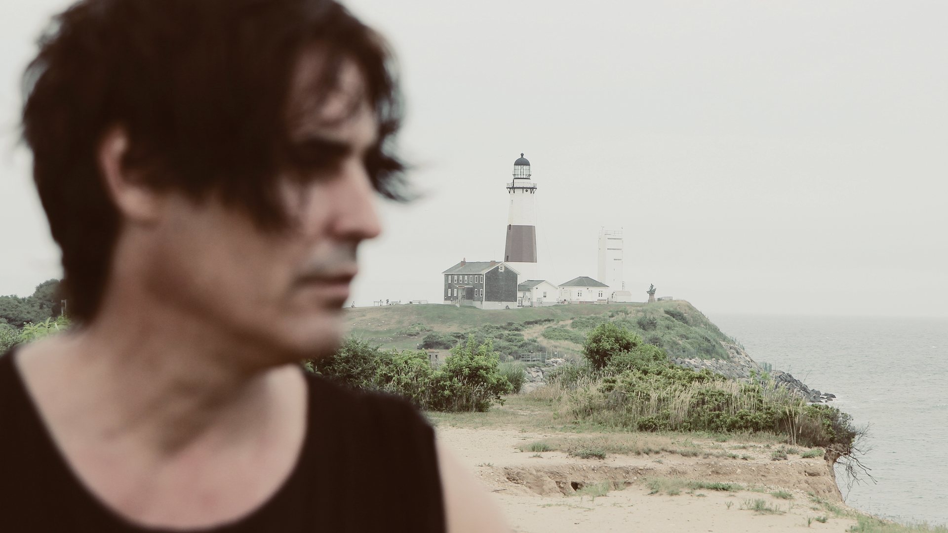 Portrait of Raphael Mazzucco in front of a coastal lighthouse
