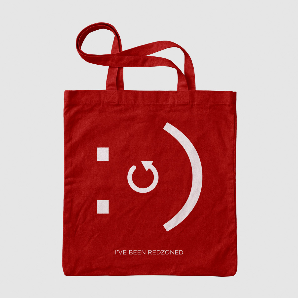 Red Redzone tote bag with a smiley face logo and the line ‘I’ve been Redzoned’
